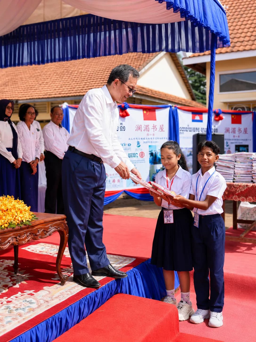 Officials and students at a book donation ceremony